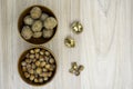 Hazelnuts and walnuts in a bowl with a few cracked next to it on the table. Flat lay. Royalty Free Stock Photo