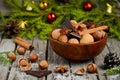 Hazelnuts and walnuts with chocolate and cinnamon in a wooden bowl Royalty Free Stock Photo