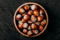 Hazelnuts. Whole Hazelnuts in wooden bowl on dark background