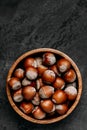 Hazelnuts. Whole Hazelnuts in wooden bowl on dark background