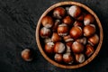 Hazelnuts. Whole Hazelnuts in wooden bowl on dark background