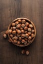 Hazelnuts in wooden bowl on the brown table Royalty Free Stock Photo