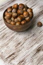 Hazelnuts in wooden bowl on rustic background Royalty Free Stock Photo