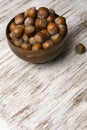 Hazelnuts in wooden bowl on rustic background Royalty Free Stock Photo