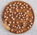 Hazelnuts on a wooden plate on the table. Top view. Royalty Free Stock Photo