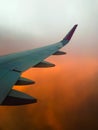 Hazy airplane wing view sunny cinematic panorama during flight over land Royalty Free Stock Photo