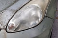 Hazy opaque foggy front head lamp of car reduces light pass-through and driving visibility