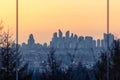 Hazy sunrise view of the Vancouver skyline from Stanley Park at Lions Gate Bridge Royalty Free Stock Photo