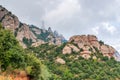 Hazy unusual mountains with green trees and cloudy sky near Montserrat Monastery,Spain