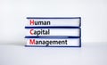 HCM, Human capital management symbol. Concept words HCM, Human capital management on books on a beautiful white background.