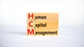 HCM, Human capital management symbol. Concept words HCM, Human capital management on wooden blocks on a beautiful white background