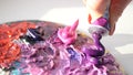 HD. artist squeezes from the tube to the palette purple oily paint. Royalty Free Stock Photo