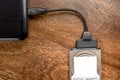 Hdd 2.5 internal hard drive disk connected to laptop via sata usb cable on wooden table closeup view Royalty Free Stock Photo
