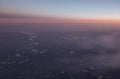 HDR Aerial photo of the landscape with clouds, mountains and landscape with snowy patches during sunset Royalty Free Stock Photo