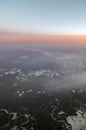 HDR Aerial photo of the landscape with clouds, mountains and landscape with snowy patches during sunset Royalty Free Stock Photo