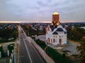 HDR aerial view of old church near river and bridge in small european city at epic sunset Royalty Free Stock Photo