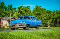 HDR - American blue classic car on the country road in Santa Clara - Serie Cuba Reportage Royalty Free Stock Photo