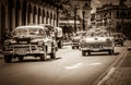 HDR - American Chevrolet classic cars and a Ford Fairlane classic car with white roof drives o Royalty Free Stock Photo