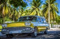 HDR - American golden Ford Brookwood parked under palms near the beach in Varadero Cuba - Serie Cuba Reportage