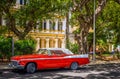 HDR - American red classic car with white roof parked on the side street in Havana Cuba - Serie Cuba Reportage