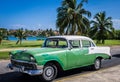 HDR beautiful green classic car with white roof in VIlla Clara Cuba
