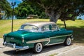 HDR beautiful green vintage car before a hotel in Havanai Cuba