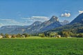 HDR beautiful landscape with lush green grass land and Alpine mountains near Wolfgangsee lake in Austria. Royalty Free Stock Photo