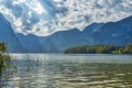 HDR beautiful landscape view of mountains with dramatic cloudy sky above a lake near Hallstatt village in Austria. Royalty Free Stock Photo