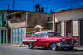 HDR - Beautiful red american vintage car with a white roof parked in Havana Cuba - Serie Cuba Reportage Royalty Free Stock Photo