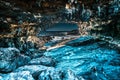 HDR of a cave leading to sea with ice look alike rocks and stalactite