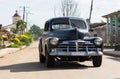 HDR Cuba countryside american black Oldtimer drives on the road