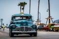 HDR Cuba green american Oldtimer drives on the Malecon Promenade in Havana