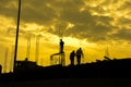 HDR effect of silhouette workers working at building construction side at sunset time