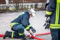 HDR - firefighter in action and connects two fire hoses