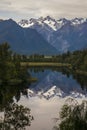 Amazing nature view of calm mountain Lake Matheson, mirror reflection in water reflecting the peaks of Southern Alps, Fox Glacier Royalty Free Stock Photo