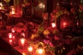 HDR long exposure night image of decorations and candles burning on grave in a cemetery during the All Saints Day in CZ