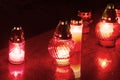 HDR long exposure night image of decorations and candles burning on grave in a cemetery during the All Saints Day in CZ