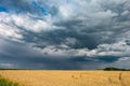 Hdr panorama on asphalt road among fields in evening with awesome black clouds before storm