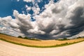 Hdr panorama on gravel road among fields in evening with awesome black clouds before storm