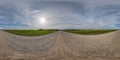 360 hdr panorama on no traffic yellow sand gravel road among fields with overcast sky with white clouds in equirectangular