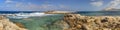 HDR panorama photo of a sunny day at the rocky sea coast with deep blue clean water and small rock formations Royalty Free Stock Photo