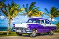 HDR - Parked american white blue vintage car in the front-side view on the beach in Havana Cuba - Serie Cuba Reportage Royalty Free Stock Photo