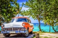 HDR - Parked american white orange Ford Fairlane vintage car in the front view on the beach in Varadero Cuba - Serie Cuba Reportag