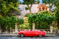 HDR - Red american convertible vintage car parked before the historical fortress el Morro in Havana Royalty Free Stock Photo