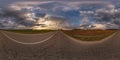 360 hdri panorama on asphalt road with evening clouds on evening sky in golden hour before sunset in equirectangular spherical Royalty Free Stock Photo