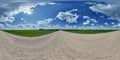 hdri 360 panorama of blue sky with awesome clouds on roadside of gravel road among fields in equirectangular full seamless Royalty Free Stock Photo