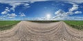 hdri 360 panorama of blue sky with awesome clouds on roadside of gravel road among fields in equirectangular full seamless Royalty Free Stock Photo