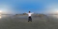 360 hdri panorama with happy man joyfully stands on seashore in rays of evening tropical sun in equirectangular spherical seamless