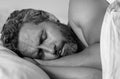 Head on bed close up. Male model sleep in white bed. Sexy shirtless man sleep in bed at bedroom. Hispanic mature man Royalty Free Stock Photo