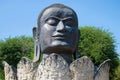 Head of the black Buddha in the lotus flower closeup. Ancient sculpture in the buddhist temple of Wat Thammikarat. Ayutthaya, Thai